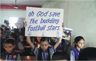  ?? SAM PANTHAKY/AFP/GETTY IMAGES ?? Schoolchil­dren in Ahmedabad, India, hold placards Monday during a prayer for the rescue of the Thai soccer team that’s stuck in a cave.