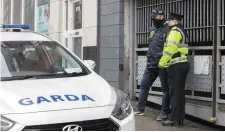  ??  ?? Gardaí on duty outside the apartments where arrests were made and firearms seized in Gardener Street in Dublin