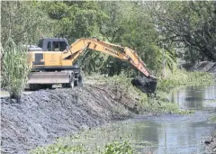  ?? VARUTH HIRUNYATHE­B ?? Dredging is under way at a canal in Bangkok’s Nong Chok district. The work is to improve water flow to deal with future floods.