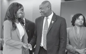  ?? LAUREN WITTE lwitte@miamiheral­d.com ?? Sue-Ann Robinson joins Benjamin Crump at a press conference to urge President Joe Biden to nominate a Black woman to replace the late Judge Marcia Cooke. The event was held at the Carlton Fields law firm on Tuesday in Miami.