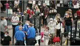  ??  ?? Travelers wear face coverings in the line for the south north security checkpoint in the main terminal of Denver Internatio­nal Airport Tuesday, Aug. 24, 2021, in Denver.