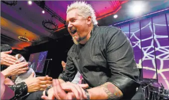  ??  ?? Kabik Photo Group Star chef Guy Fieri greets people at the Salute to Vegas Heroes dinner Saturday at Caesars Palace.