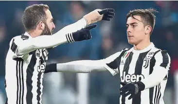  ??  ?? Dynamic duo: Juventus’ Gonzalo Higuain (left) celebratin­g with Paulo Dybala after scoring against Genoa in the Italian Cup last-16 match on Wednesday.