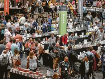  ?? Photos by Jon Shapley / Staff photograph­er ?? People look for books at tables set up by LifeWay Christian Resources at the Birmingham­Jefferson Convention Complex on Monday, the eve of the Southern Baptist Convention’s meeting.