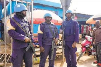  ?? Sam Mednick Associated Press ?? U.N. PEACEKEEPE­RS guard a market in Bouar, Central African Republic. Nearly 5,000 fighters have taken part in a disarmamen­t program launched in 2015. Yet many return to fighting or struggle to find other work.