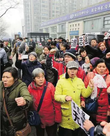  ?? AP ?? Unfair call Above: Supporters of prominent rights lawyer Pu Zhiqiang chant slogans while protesting his charges near the 2nd Beijing Intermedia­te People’s Court yesterday.