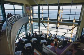 ?? ERIC RISBERG — THE ASSOCIATED PRESS ?? Diners enjoy lunch and the view in the Sutro’s room at the renovated Cliff House restaurant in 2004. The venerable eatery will be closing its doors for good at the end of the month.
