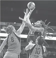  ?? ?? The Mercury’s Brittney Griner shoots over the Aces’ Carolyn Swords and Kelsey Plum during the first half of Thursday night’s game at Talking Stick Resort Arena.