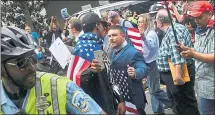  ?? NICHOLAS KAMM — AGENCE FRANCE-PRESSE VIA GETTY IMAGES ?? Police escort Unite the Right organizer Jason Kessler, center, during a white nationalis­t rally at a park opposite the White House on Sunday.