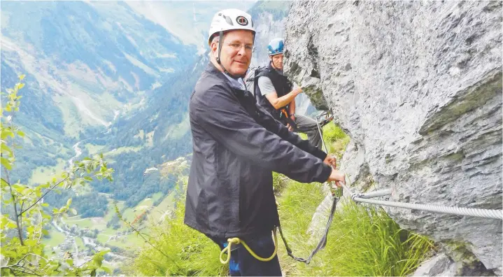  ?? — RICK STEVES ?? Living the high life: Terrified travel writer Rick Steves is buckled up to embark on the via ferrata — the “iron way” — for a much different view of the Swiss Alps.