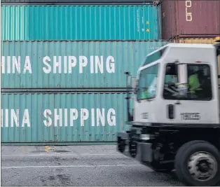  ?? AP PHOTO ?? A jockey truck passes a stack of 40-foot China Shipping containers earlier this year at the Port of Savannah in Savannah, Ga.