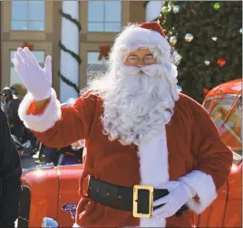  ?? STAFF PHOTO BY MARTY MADDEN ?? Santa Claus waves to a crowd in this file photo.