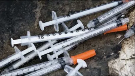  ?? ASSOCIATED PRESS ?? Discarded syringes pile up near a popular heroin shooting area near near train tracks in Philadelph­ia.