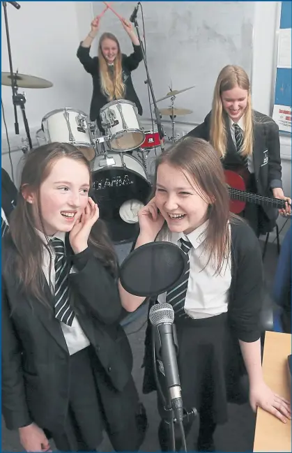  ??  ?? (Left to right) Olivia Brew, Carrie Henderson and Andrea Gilchrist and in the background on drums, Emily Thomson, all aged 13