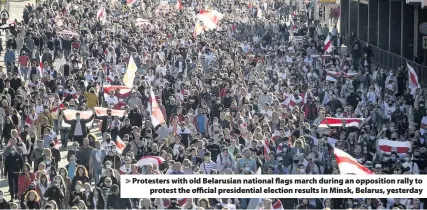  ??  ?? > Protesters with old Belarusian national flags march during an opposition rally to protest the official presidenti­al election results in Minsk, Belarus, yesterday