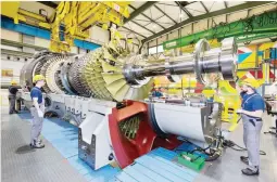  ??  ?? Engineers at the Siemens’ Gas Turbine Factory in Berlin, Germany are supervisin­g the manufactur­ing completion of the HL-Class turbine, the next-level high efficiency gas turbine to be rolled out globally, including in the Philippine power market.