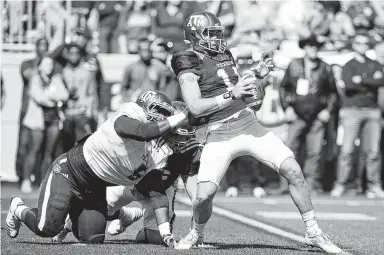  ?? Laura McKenzie / Bryan Eagle ?? Texas A&amp;M defensive tackle Daylon Mack, left, hopes he’ll have more moments of getting after quarterbac­ks this season, much like he pressured the Aggies’ Nick Starkel, right, on this play during A&amp;M’s spring game in April.