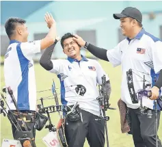  ?? — Bernama photo ?? Lee Kin Lip (left), Alang Arif Aqil Muhammad Ghazali (centre) and Mohd Juwaidi Mazuki celebrate after winning their third/fourth match.