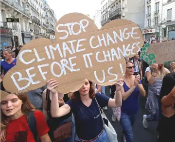  ??  ?? Protesters in Paris march to urge politician­s to act against climate change on Oct 13. — Reuters photo