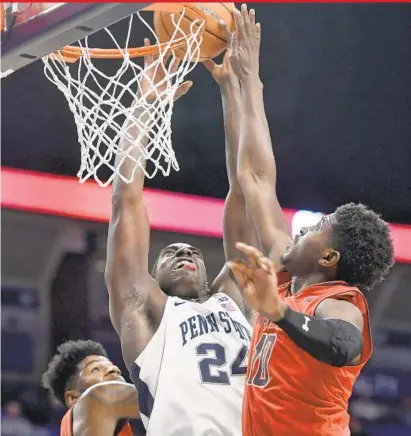  ?? ABBY DREY/ASSOCIATED PRESS ?? Maryland guard Darryl Morsell, right, blocks a shot by Penn State’s Mike Watkins during Wednesday’s Big Ten matchup in State College, Pa. Morsell, a freshman from Mount Saint Joseph, scored 10 points and also had three assists for the Terps.