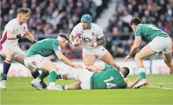  ?? ?? England's Jack Nowell (centre) evades being tackled by Ireland's Andrew Conway (floor) during the Guinness Six Nations match at Twickenham.