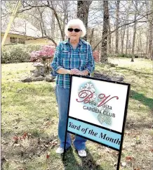  ?? Photo submitted ?? Pene Pigott stands by the sign declaring she had the Yard of the Month in April of this year.