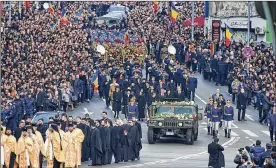  ?? NICOLAE BURCA GIN / ASSOCIATED PRESS ?? People watch as the coffin of late Romanian King Michael is driven to the patriarcha­l cathedral, in Bucharest, Romania, on Saturday.