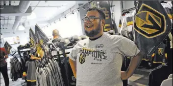  ?? Rachel Aston Las Vegas Review-Journal @rookie__rae ?? Faustino Solis tries on his Knights shirt May 20 at The Arsenal retail store at City National Arena. The store sold 150 conference championsh­ip shirts in a half-hour.