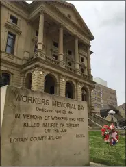  ?? RICHARD PAYERCHIN — THE MORNING JOURNAL ?? A new wreath sits at the monument that marks Workers Memorial Day outside the Old Lorain County Courthouse on April 28.