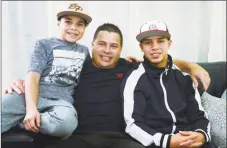  ?? Erik Trautmann / Hearst Connecticu­t Media ?? Jose Vasquez, with his sons, Alan, 11, and Jose, 14, on Wednesday at their home in Norwalk.