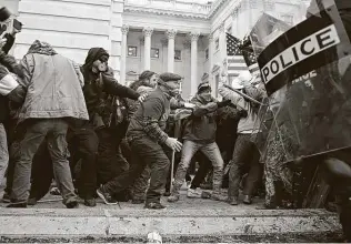  ?? Brendan Smialowski / AFP / Getty Images ?? Attempted coup d’état, a total national shame, a display worthy of citizens of a banana republic — that’s how readers are reacting to the deadly protest in Washington, D.C., by supporters of President Donald Trump.