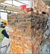  ??  ?? Most of this chimney at 50 to 52 Main Street dates to the late 18th century, before 44 Main Street was built. The mortar had long since failed and the chimney had to be partially taken down before re-building, which is underway in this photograph.