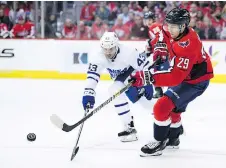  ?? THE ASSOCIATED PRESS ?? Washington’s Christian Djoos is pursued by the Leafs’ Nazem Kadri on Saturday as Toronto beat the Stanley Cup champs 4-2.