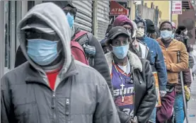  ?? BEBETO MATTHEWS / AP ?? People wait for a distributi­on of masks and food from the Rev. Al Sharpton in the Harlem neighborho­od of New York last April.