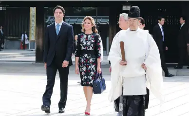  ?? SHUJI KAJIYAMA / THE ASSOCIATED PRESS ?? Prime Minister Justin Trudeau and wife Sophie Grégoire Trudeau visit the Meiji Shrine in Tokyo. The prime minister is expected to advocate for government spending over austerity when he meets with G7 leaders Thursday in Japan.