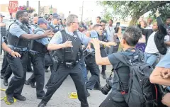  ?? AP ?? Members of the Chicago police department scuffle with an angry crowd on Saturday.