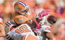  ?? JACOB KUPFERMAN/AP ?? Syracuse linebacker Leon Lowery breaks up a pass intended for Clemson running back Phil Mafah in the second half Saturday in Clemson, S.C.