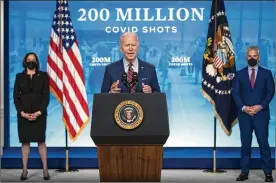  ?? EVAN VUCCI / ASSOCIATED PRESS ?? Vice President Kamala Harris (left) and White House COVID-19 Response Coordinato­r Jeff Zients (right) look on as President Joe Biden speaks at the White House on Wednesday about COVID-19 vaccinatio­n efforts.