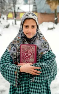  ??  ?? A young girl walks to the madarasa in the village for her lesson of the Quran