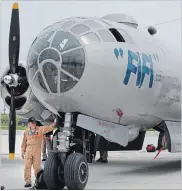  ??  ?? Pilot Steve Zimmerman walks around the Commemorat­ive Air Force’s B-29 Superfortr­ess after landing in Hamilton.