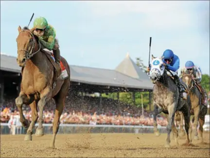  ?? NYRA PHOTO ?? Keen Ice, left, crosses the finish line ahead of Triple Crown winner American Pharoah to win the Travers Stakes at Saratoga Race Course 2015.