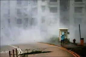  ?? ROY LIU/ CHINA DAILY ?? Strong winds hurl rain and sea spray at a man taking a walk in Heng Fa Chuen during the Signal No 10 storm as Typhoon Hato pounded Hong Kong on Wednesday.