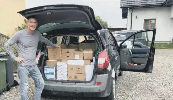  ?? ?? Graeme Warnell receiving the donated phones in Poland.