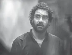  ??  ?? File photo shows Abdel Fattah standing in the defendant’s cage during his trial in Cairo.