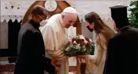  ?? AP PHOTO BY ANDREW MEDICHINI ?? Pope Francis is welcomed upon his arrival at the Sayidat al-nejat (Our Lady of Salvation) Cathedral, in Baghdad, Iraq, Friday, March 5. Pope Francis has arrived in Iraq to urge the country’s dwindling number of Christians to stay put and help rebuild the country after years of war and persecutio­n, brushing aside the coronaviru­s pandemic and security concerns.