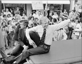  ?? AP PHOTO/BOB DAUGHERTY, FILE ?? President Jimmy Carter waves from the roof of his car along the parade route through Bardstown, Ky., July 31, 1979.