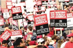  ??  ?? Thousands of Writers Guild of America members and supporters hold signs during a large strike in Los Angeles, California, on Nov 9, 2007. — Reuters file photo