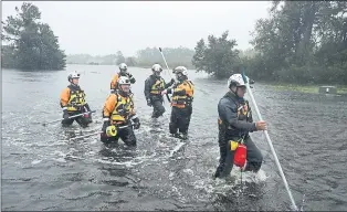  ?? CHIP SOMODEVILL­A — GETTY IMAGES ?? Members of the FEMA Urban Search and Rescue Task Force 4 from Oakland search a flooded neighborho­od for evacuees during Hurricane Florence Friday in Fairfield Harbour, N.C.