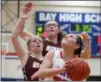  ?? RANDY MEYERS — FOR THE MORNING JOURNAL ?? Maeve Johnston of Bay looks for room to shoot against Taylor Spies and Kelsey Murphy of Rocky River on Feb. 13.