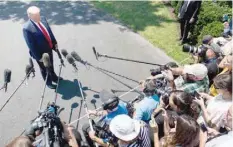  ?? — AFP ?? US President Donald Trump speaks to the media after arriving on the South Lawn of the White House in Washington on Tuesday, following a trip to the 400th anniversar­y of Jamestown, Virginia.